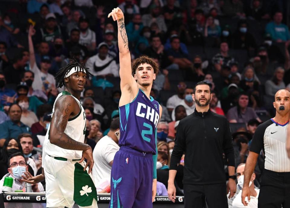 Charlotte Hornets guard LaMelo Ball, center, strikes a pose as he watches the flight of his three-point shot during second-half action against the Boston Celtics at Spectrum Center in Charlotte, NC on Monday. The Celtics defeated the Hornets 140-129 in overtime, although Ball hit 7 three-pointers.