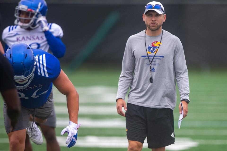 Kansas defensive back coach Jordan Peterson watches players run drills during practice Thursday morning.