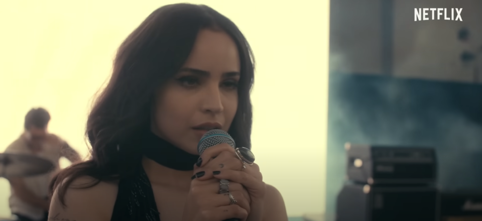 Sofia Carson holding a microphone