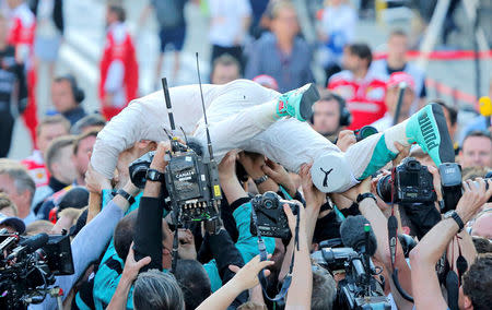 Formula One - Russian Grand Prix - Sochi, Russia - 1/5/16 - Mercedes F1 driver Nico Rosberg of Germany celebrates victory with team members after the Russian Grand Prix. REUTERS/Maxim Shemetov