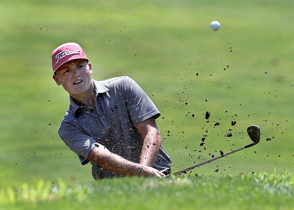 Tug Schwab chips the ball out of a sand trap on the 10th hole during the Drysdale Junior Golf Tournament Thursday July 14, 2022.