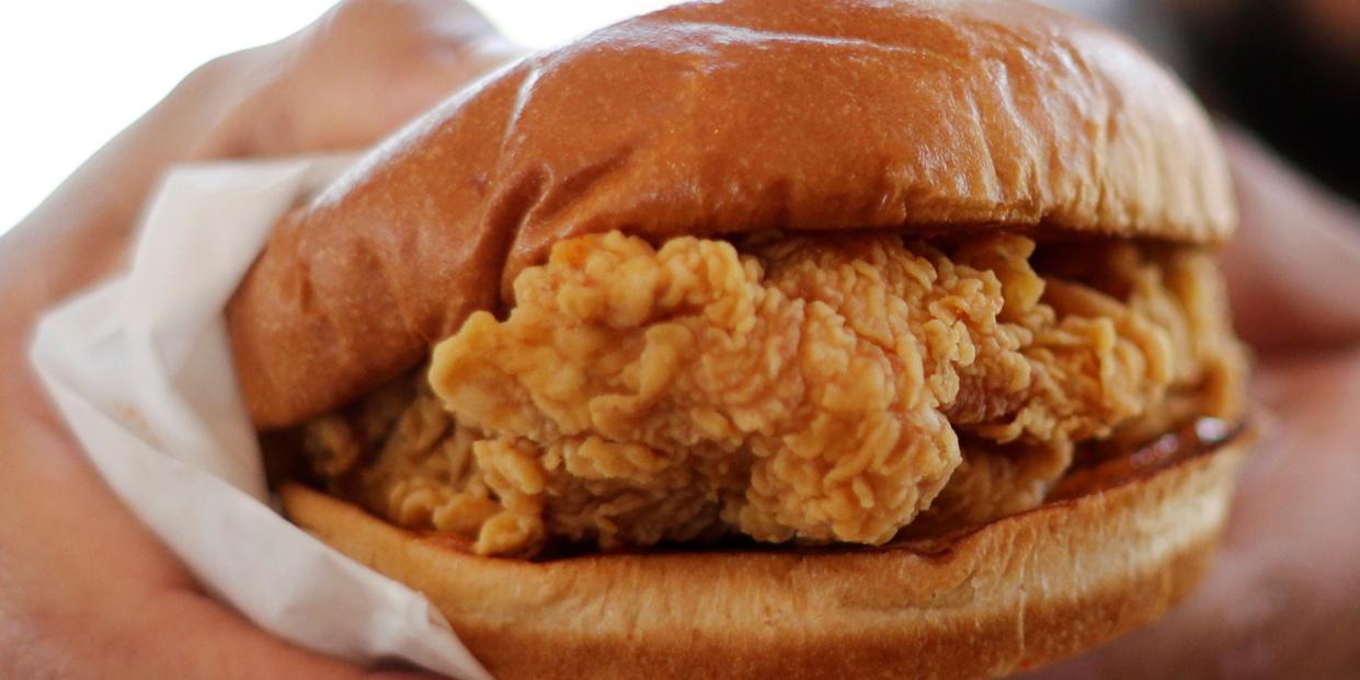 Randy Estrada holds up his chicken sandwiches at a Popeyes, Thursday, Aug. 22, 2019, in Kyle, Texas. After Popeyes added a crispy chicken sandwich to their fast-fast menu, the hierarchy of chicken sandwiches in America was rattled, and the supremacy of Chick-fil-A and others was threatened. It’s been a trending topic on social media, fans have weighed in with YouTube analyses and memes, and some have reported long lines just to get a taste of the new sandwich. (AP Photo/Eric Gay)