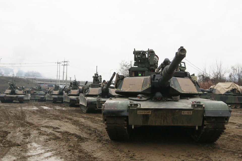 FILE - In this Dec. 10, 2015, file photo, U.S. M1A2 SEP Abrams battle tanks prepare to cross the Hantan river during a river crossing operation, part of an annual joint military exercise between South Korea and the United States against a possible attack from North Korea, in Yeoncheon, south of the demilitarized zone that divides the two Koreas, South Korea. A U.S. military base in South Korea accidentally blared an alert siren instead of a bugle call, causing a brief scare just as the U.S. and its allies are monitoring for signs of a provocation from North Korea, which has warned it could send a "Christmas gift" over deadlocked nuclear negotiations. (AP Photo/Ahn Young-joon, File)