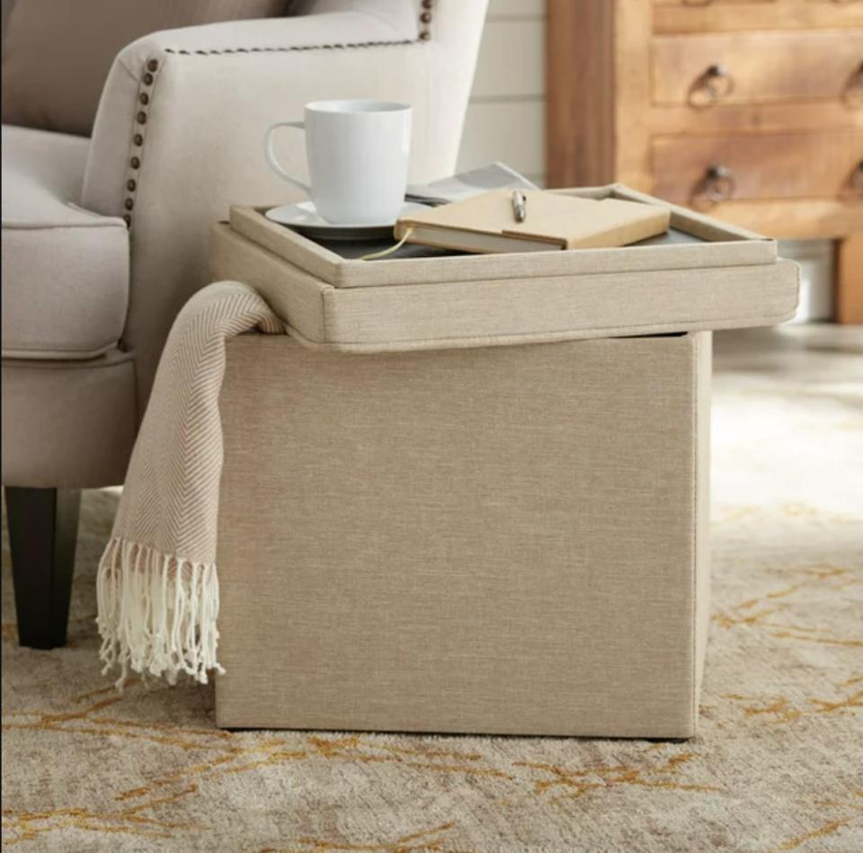 an ottoman with a lid that turns into a tray, a blanket stored inside, in a living room