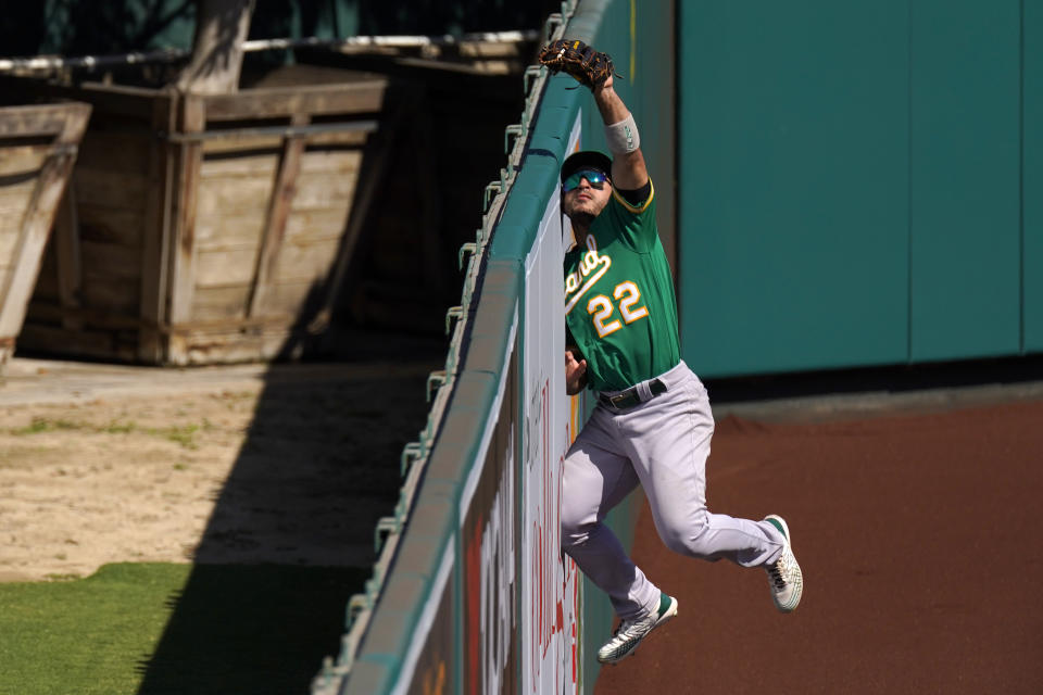 Oakland Athletics center fielder Ramon Laureano makes a catch at the wall on a ball hit by Los Angeles Angels' Brian Goodwin during the seventh inning of a baseball game Wednesday, Aug. 12, 2020, in Anaheim, Calif. (AP Photo/Mark J. Terrill)