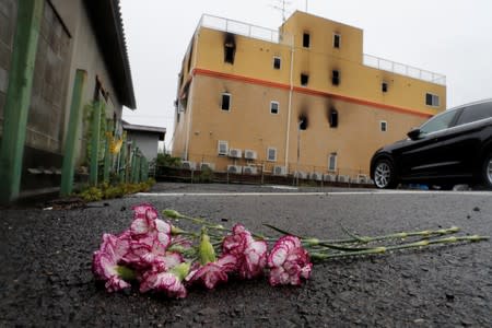 Flowers are placed in front of the torced Kyoto Animation building in respect for the victims, in Kyoto