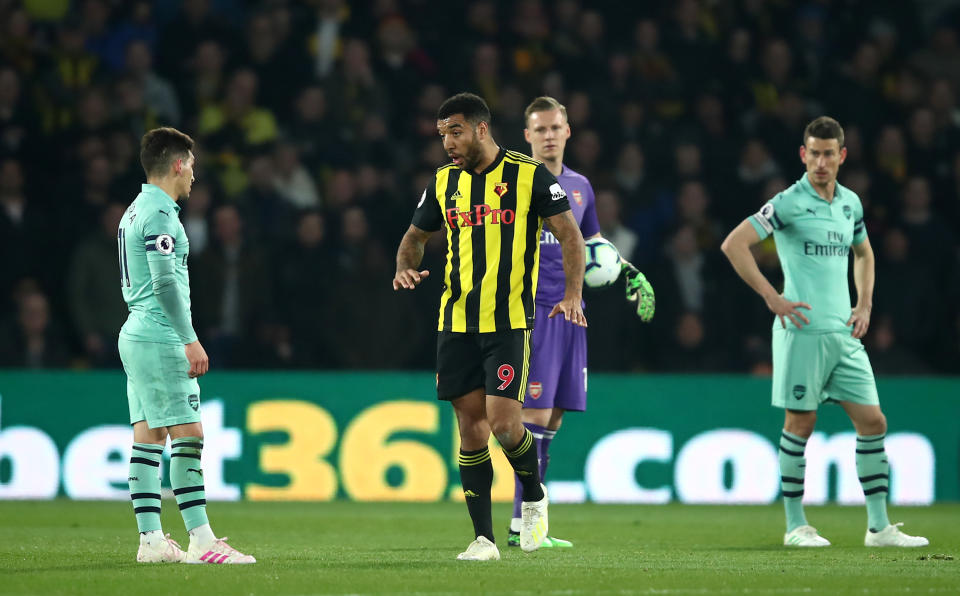 Troy Deeney of Watford leaves the field after being shown a red card for elbowing Lucas Torreira.