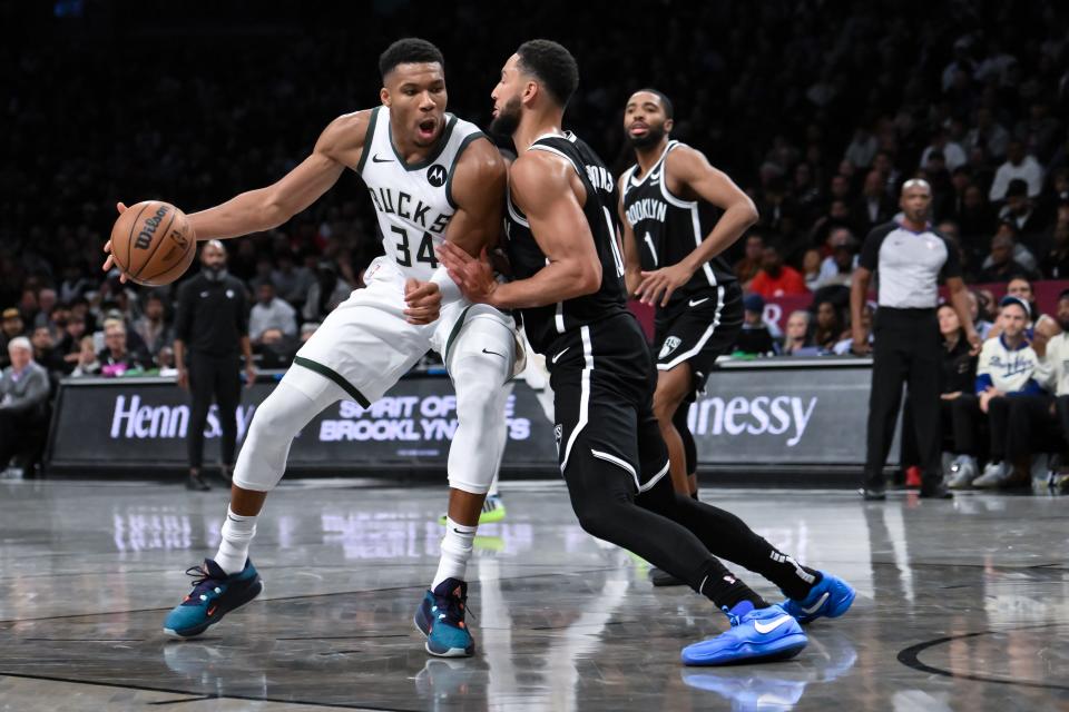 Milwaukee Bucks forward Giannis Antetokounmpo posts up against Brooklyn Nets guard Ben Simmons during the fourth quarter at Barclays Center.