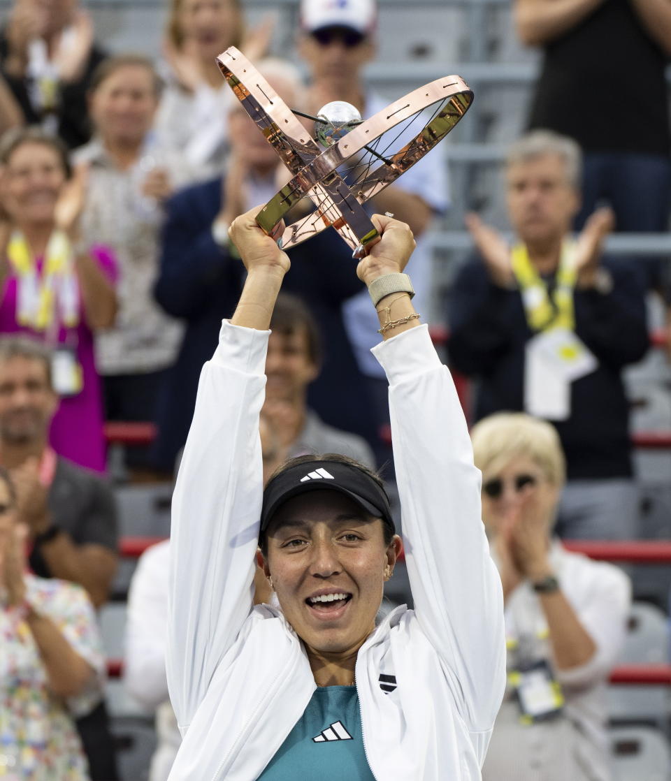 Jessica Pegula, of the United States, lifts the trophy following her win over Liudmila Samsonova, of Russia, in the women's final of the National Bank Open tennis tournament in Montreal, Sunday, Aug. 13, 2023. (Christinne Muschi/The Canadian Press via AP)