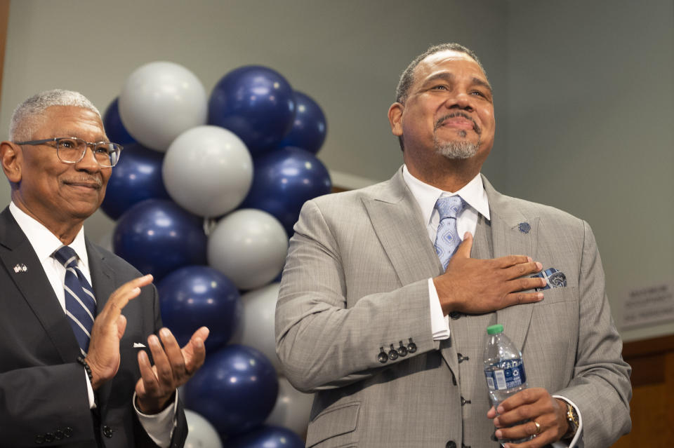 Georgetown University Director of Intercollegiate Athletics Lee Reed, left, introduces their new men's NCAA college basketball head coach Ed Cooley, right, in Washington, Wednesday, March 22, 2023. (AP Photo/Cliff Owen)