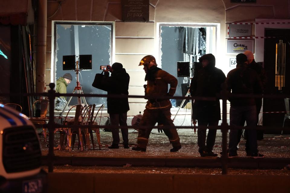 Russian investigators work at the side of an explosion at a cafe in St. Petersburg, Russia, Sunday, April 2, 2023. An explosion tore through a cafe in the Russian city of St. Petersburg on Sunday, and preliminary reports suggested a prominent military blogger was killed and more than a dozen people were injured. (AP Photo)