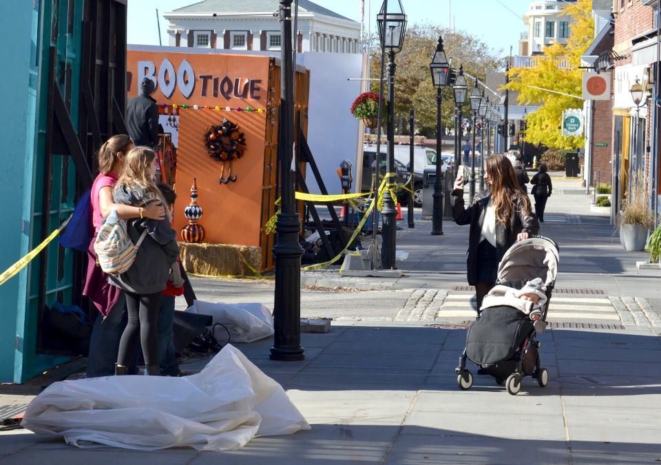 Passersby get their photo taken near the film set of 'Hocus Pocus 2' in Newport on Monday, Nov. 8, 2021.