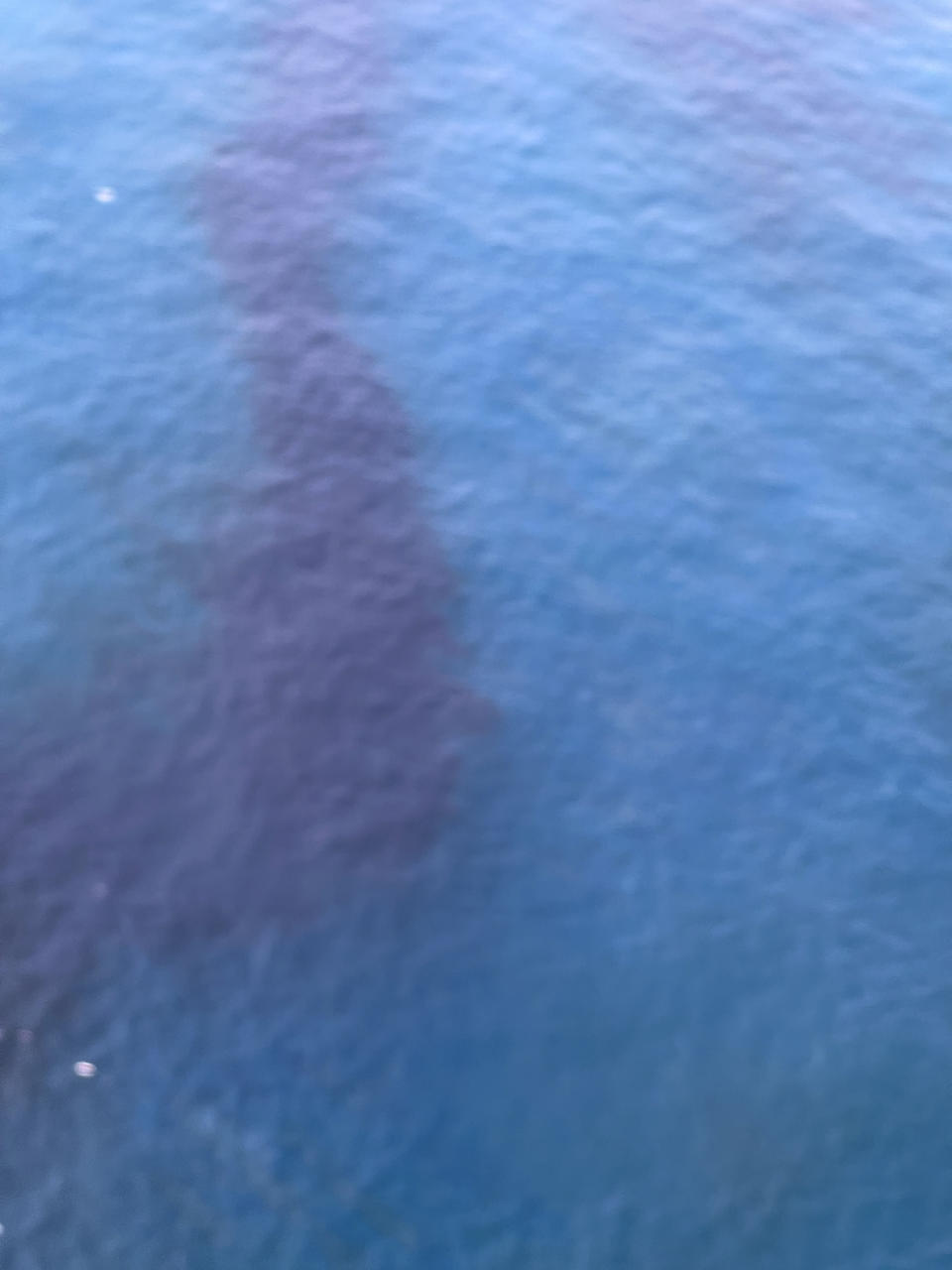 In this photo released by the Royal Thai Navy, an aerial view from a navy plane shows a large oil spill off the coast of Rayong, eastern Thailand, Thursday, Jan. 27, 2022. A special aircraft from a company specializing in recoveries from oil spills has arrived Thursday from Singapore to join an urgent effort to clean up an oil slick before it could hit beaches in eastern Thailand. (Royal Thai Navy via AP)