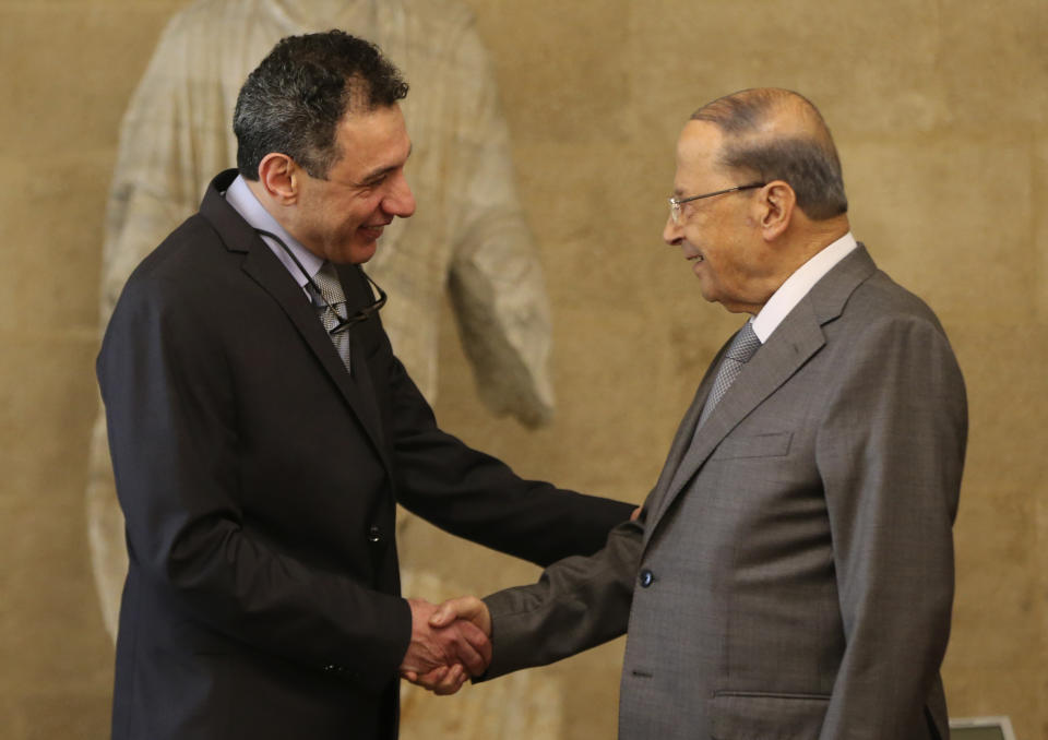 Lebanese President Michel Aoun, right, shakes hands with Nizar Zakka, a Lebanese citizen and U.S. permanent resident, who was released in Tehran after nearly four years in jail on charges of spying, upon his arrival at the presidential palace, in Baabda, east of Beirut, Tuesday, June 11, 2019. Zakka was allowed to fly to Lebanon, a development that comes amid heightened tensions between Iran and the U.S. after President Donald Trump withdrew America from Tehran's nuclear deal with world powers. (AP Photo/Hussein Malla)