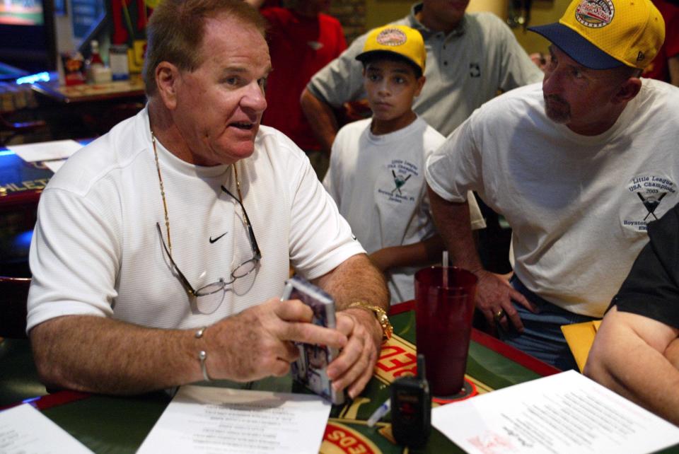 Pete Rose talks about his great moments playing baseball to East Boynton Beach Little Leaguer Jordan Irene, 12, and Manager Kenny Emerson during a dinner to honor the Little League American champions at Pete Rose Ballpark Cafe on October 2, 2003, in Boynton Beach.