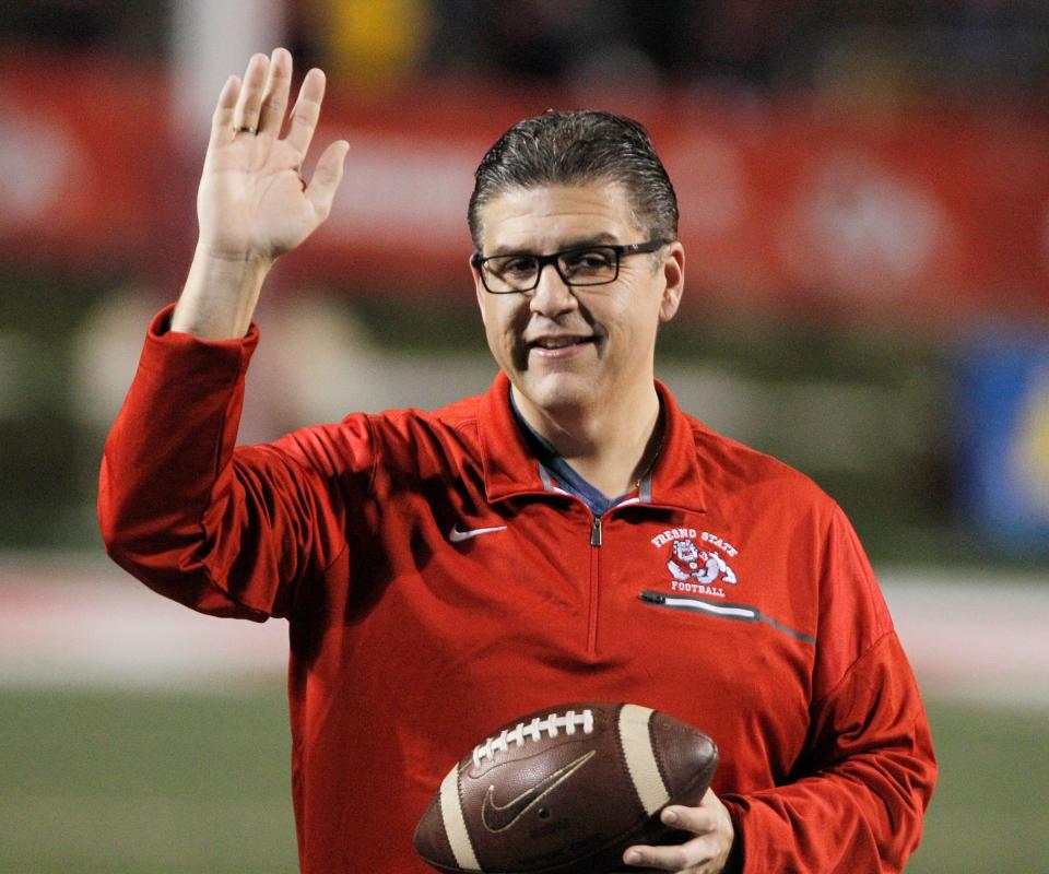 FILE - In this Nov. 4, 2017 file photo, Fresno State president Joseph I. Castro waves to the crowd before an NCAA college football game against BYU in Fresno, Calif.