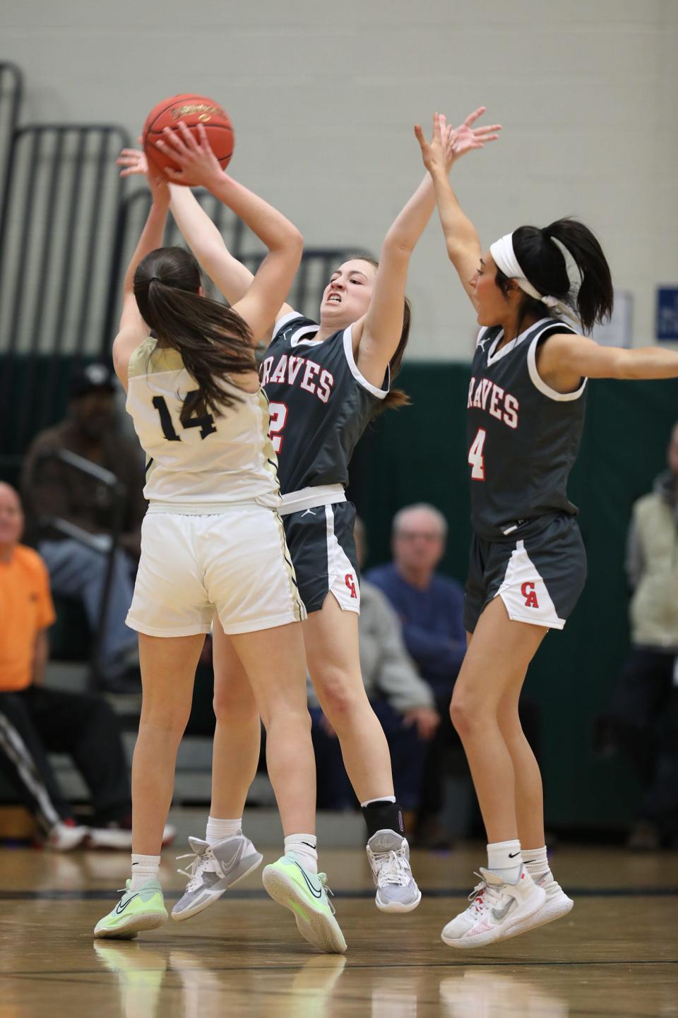 PIttsford Sutherland's Cecilia Peinado Calvo is double teamed by Canandaigua Academy's Eily Hubler and Mya Herman during first half action.