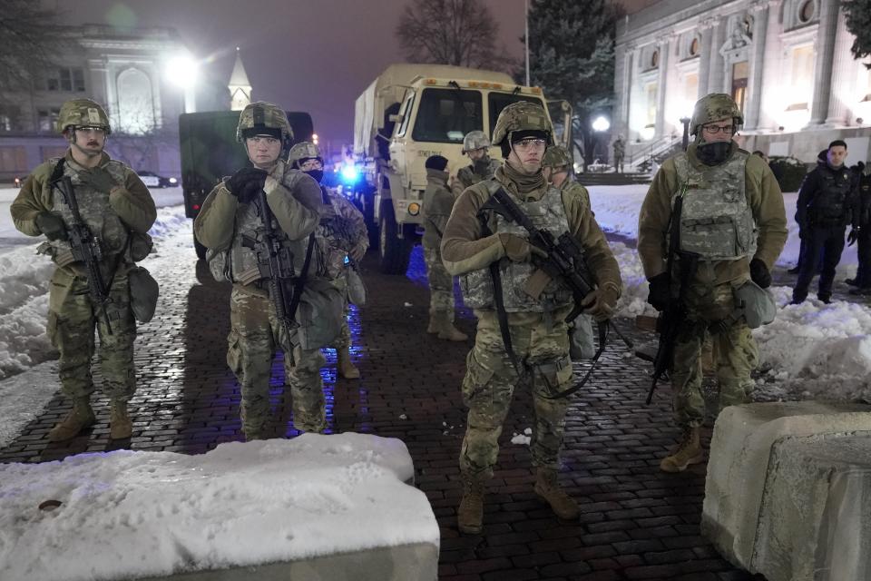 National Guard members stand outside a museum, late Tuesday, Jan. 5, 2021, in Kenosha, Wis. Earlier it was announced that no charges will be filed against the white police officer who shot Jacob Blake, a Black man, in August. (AP Photo/Morry Gash)