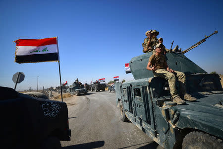 Members of Iraqi federal forces gather to continue to advance in military vehicles in Kirkuk, Iraq October 16, 2017. REUTERS/Stringer NO RESALES. NO ARCHIVES