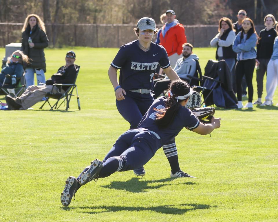 Exeter center fielder Annie Christiana makes a diving catch off a Winnacunnet hit as teammate Dejah Rondeau looks on during Friday's Division I softball game.