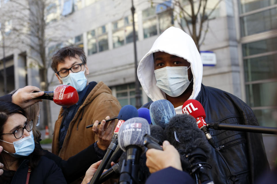 Music producer identified only by his first name, Michel, answers to media, before going to the Inspectorate General of the National Police, known by its French acronym IGPN, in Paris, Thursday, Nov. 26, 2020. French Interior Minister Gerald Darmanin ordered several Paris police officers suspended after the publication of videos showing them beating up a Black man and using tear gas against him with no apparent reason. (AP Photo/Thibault Camus)