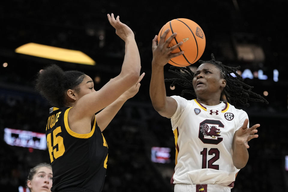 South Carolina guard MiLaysia Fulwiley (12) shoots over Iowa forward Hannah Stuelke (45) during the first half of the Final Four college basketball championship game in the women's NCAA Tournament, Sunday, April 7, 2024, in Cleveland. (AP Photo/Morry Gash)