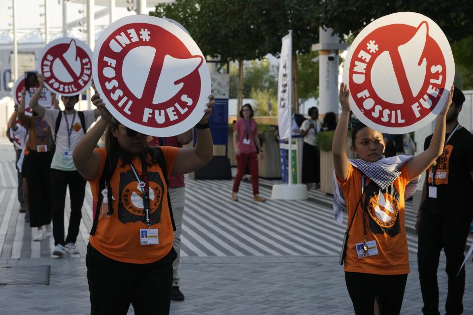 Activists protest against fossil fuels at the COP28 U.N. Climate Summit, Tuesday, Dec. 5, 2023, in Dubai, United Arab Emirates. (AP Photo/Peter Dejong)