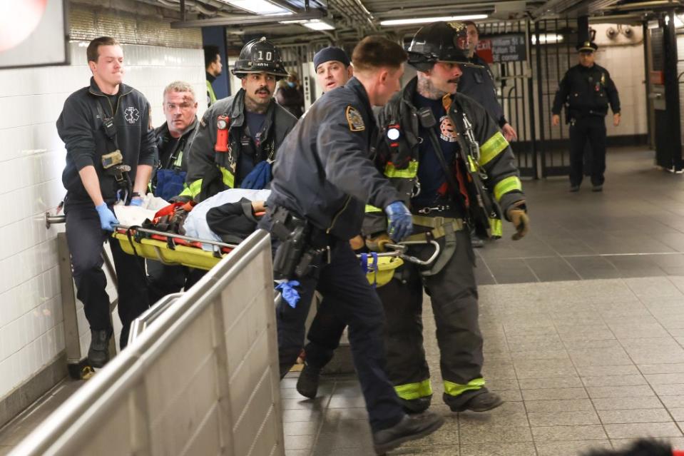 Rescuers lift woman out of the Fulton Street Station. William Farrington