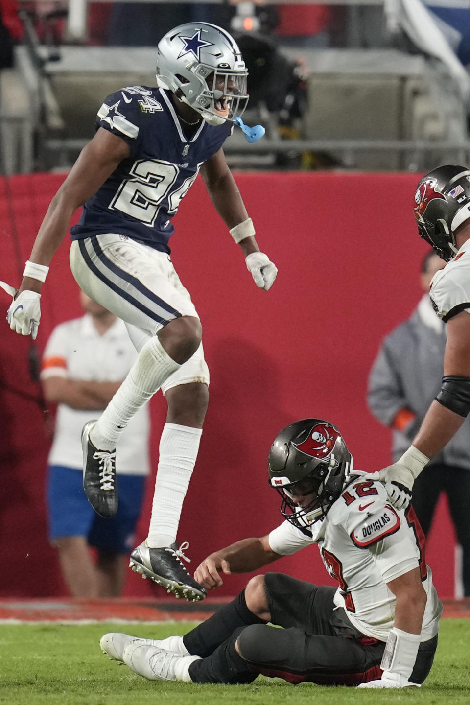 Dallas Cowboys safety Israel Mukuamu (24) celebrates the sacking of Tampa Bay Buccaneers quarterback Tom Brady (12) during the second half of an NFL wild-card football game, Monday, Jan. 16, 2023, in Tampa, Fla. (AP Photo/John Raoux)