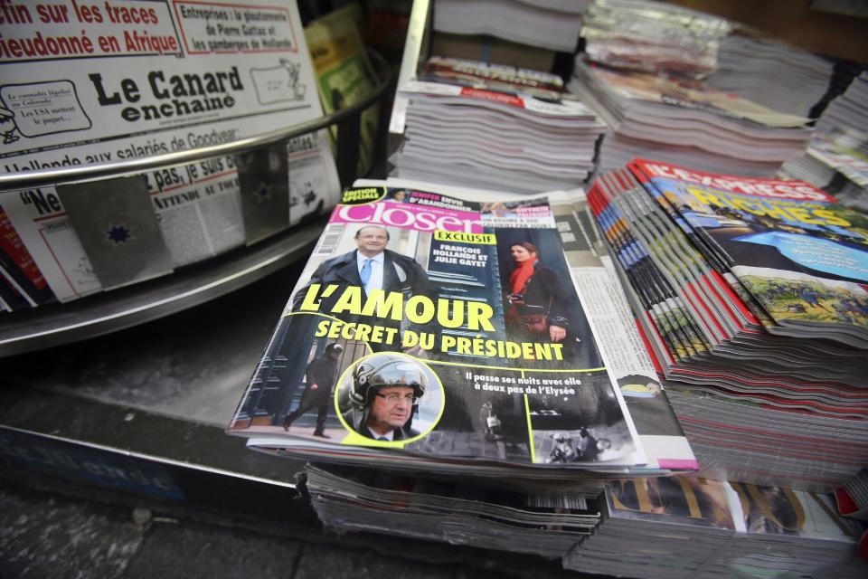 The French magazine Closer with photos of French President Francois Hollande and French actress Julie Gayet on its front page, is presented in a newspaper stall on the Champs Elysee Avenue in Paris, Friday Jan. 10, 2013. French President Francois Hollande is threatening legal action over the magazine report saying he is having a secret affair with the French actress Julie Gayet. Hollande, in a statement obtained by The Associated Press, says he "deeply deplores the attacks on respect for privacy, to which each citizen has a right." .(AP Photo/Remy de la Mauviniere)