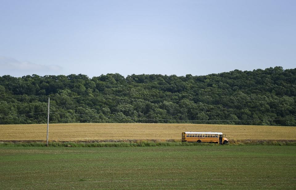 Rural students often have long bus rides to and from school. <a href="https://www.gettyimages.com/detail/news-photo/yellow-school-bus-drives-along-best-road-next-to-a-field-of-news-photo/1320548478" rel="nofollow noopener" target="_blank" data-ylk="slk:Ben Hasty/MediaNews Group/Reading Eagle via Getty Images;elm:context_link;itc:0;sec:content-canvas" class="link ">Ben Hasty/MediaNews Group/Reading Eagle via Getty Images</a>