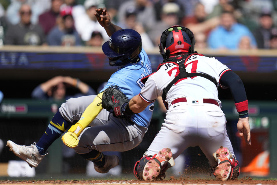 Tampa Bay Rays' Osleivis Basabe is tagged out by Minnesota Twins catcher Ryan Jeffers off a fielder's choice hit by Vidal Brujan during the second inning of a baseball game Wednesday, Sept. 13, 2023, in Minneapolis. (AP Photo/Abbie Parr)