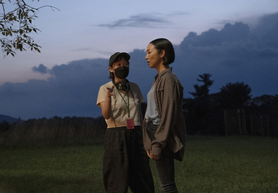 This image released by A24 shows Celine Song, left, and Greta Lee on the set of "Past Lives." (Jon Pack/A24 via AP)