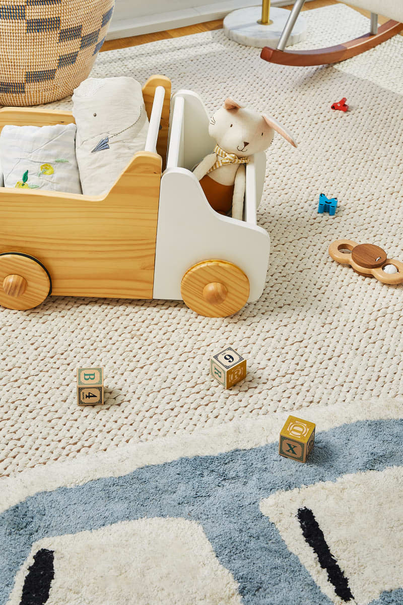 Children's toys on nursery room floor.