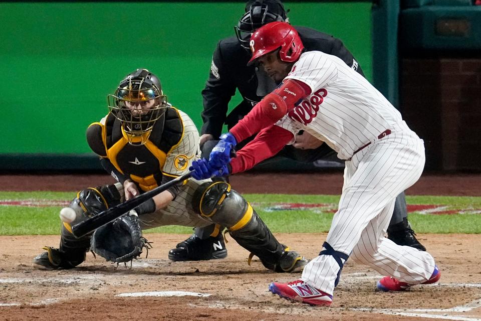 Philadelphia Phillies' Jean Segura hits a two-run single during the fourth inning in Game 3 of the baseball NL Championship Series between the San Diego Padres and the Philadelphia Phillies on Friday, Oct. 21, 2022, in Philadelphia. (AP Photo/Matt Rourke)