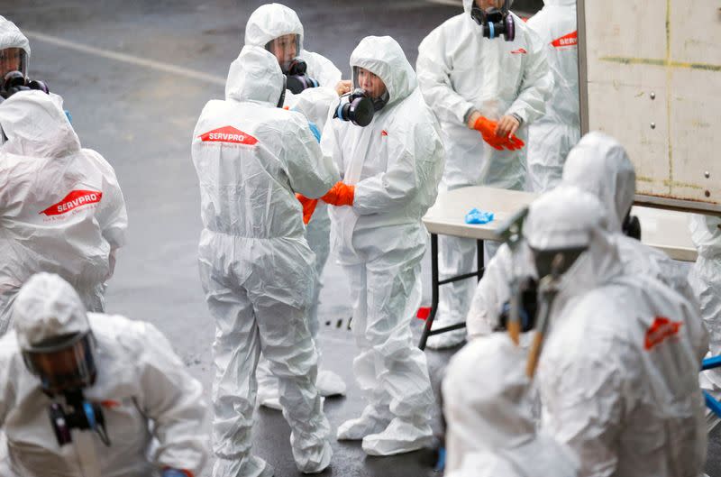 A Servpro cleaning crew put on protective gear before entering Life Care Center of Kirkland