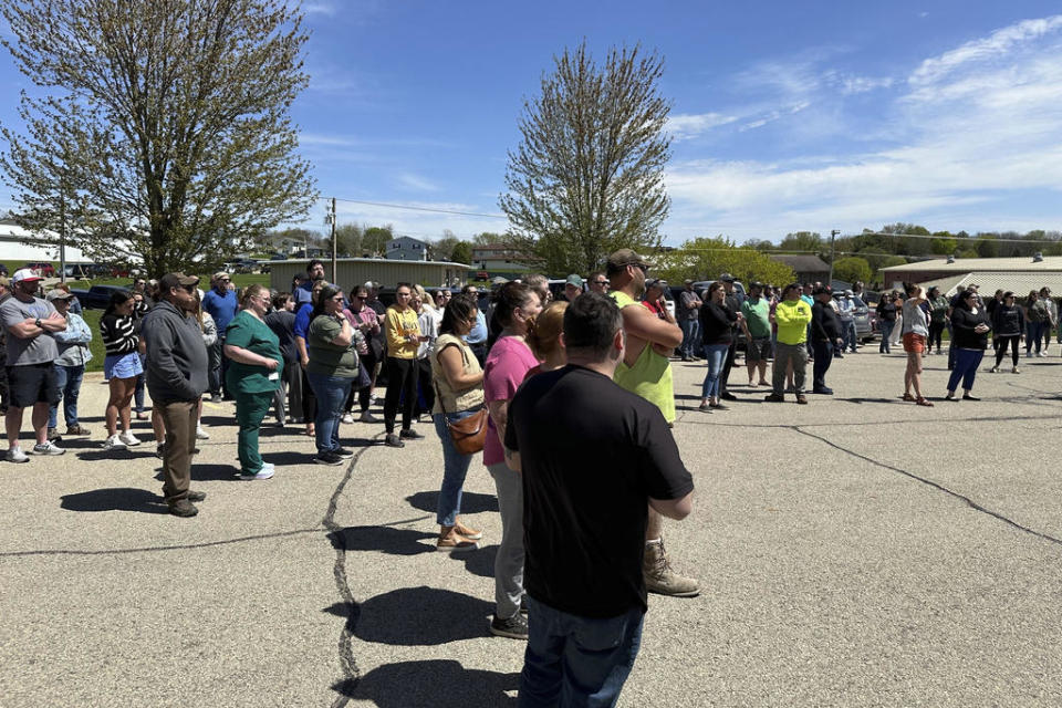 People wait for their children outside the Mount Horeb School District bus station in Mount Horeb, Wis., where students were taken after an active shooter situation at the middle school, Wednesday, May 1, 2024. Authorities said without giving details that the 