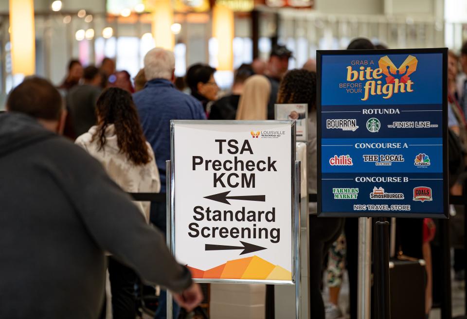 Holiday travelers wait in line for screening at the Muhammad Ali International Airport in Louisville, Ky. on Nov. 21, 2023.