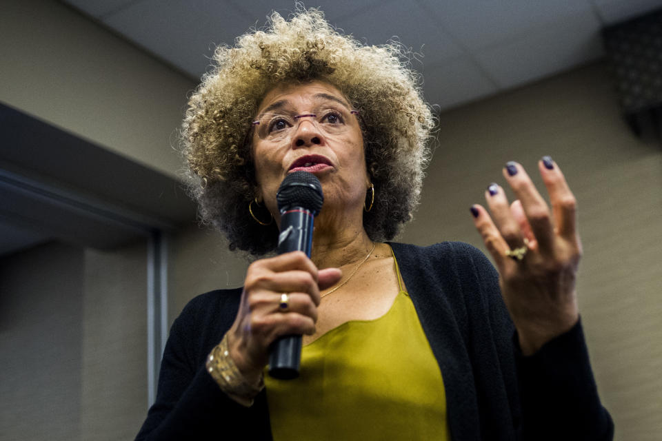 FILE- In this Feb. 19, 2015, file photo Angela Davis, author, educator and iconic civil rights activist, speaks during her visit to the University of Michigan-Flint, in Flint, Mich. The Birmingham Civil Rights Institute in Alabama announced Saturday, Jan. 5, 2019, that it has rescinded its decision to honor Davis following unspecified complaints. Davis is a Birmingham native who has spent decades fighting for civil rights. (Jake May/The Flint Journal via AP, File)