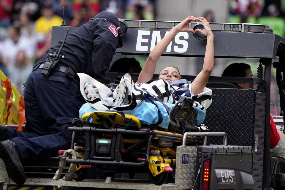 United States forward Mallory Swanson signals to fans as she is taken off the field after an injury during the first half of an international friendly soccer match against Ireland in Austin, Texas, Saturday, April 8, 2023. (AP Photo/Eric Gay)