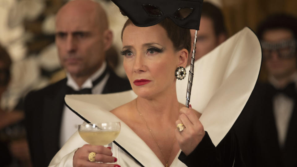 The Baroness holds a cocktail looking perturbed 