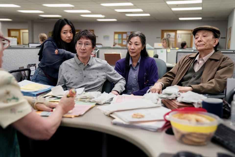 Four members of the Wang family sitting in front of a desk