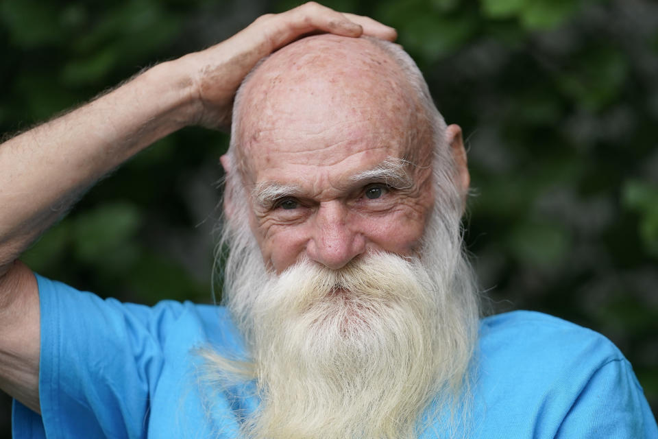 FILE — David Lidstone, 81, speaks with reporters during an interview with The Associated Press Tuesday, Aug. 10, 2021, in Boscawen, N.H. Lidstone, an off-the-grid New Hampshire hermit known to locals as "River Dave," had been living in a cabin in the woods along the Merrimack River, in Canterbury, N.H., for nearly three decades. A contempt of court hearing has been scheduled for Thursday, March 31, 2022, for Lidstone, accused of returning to live on property that he was ordered to stay away from. (AP Photo/Steven Senne, File)