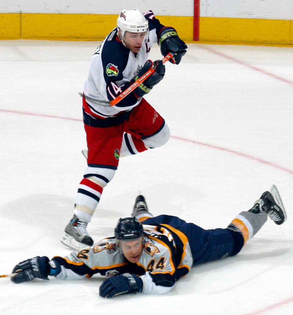 (NCL 30JAN03 BLUE LAURON ARACE) Blue Jackets Ray Whitney, 14, hops over Predators Kimmo Timonen (44) as he makes a break for the Predators goal in the third period of their game at Nationwide Areana, January 30, 2003. (Dispatch photo by Neal C. Lauron)