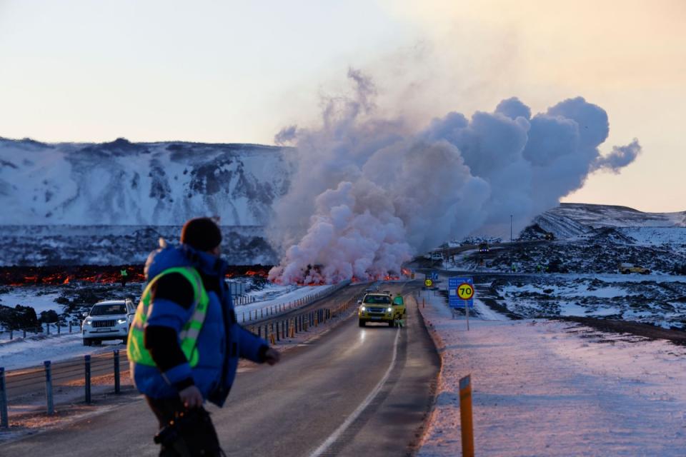 Emergency services close a road as lava erupts from a fissure in Grandavík, Iceland.<span class="copyright">Micah Garen—Getty Images</span>