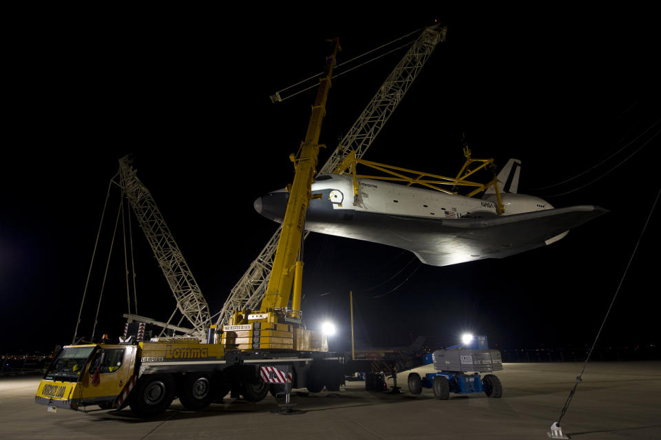 In this photo provided by NASA, the space shuttle Enterprise is lifted in preparation for its mating to the NASA 747 Shuttle Carrier Aircraft for transport to New York at Washington Dulles International Airport, Friday, April 20, 2012, in Sterling, Va. Enterprise is expected to go on display at the Intrepid Sea Air and Space Museum in New York. (AP Photo/NASA, Bill Ingalls)