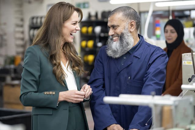 <p>Danny Lawson - WPA Pool/Getty</p> Kate Middleton chats with Senior Weaver Trainer Zeb Akhtar during a visit to AW Hainsworth on Sept. 26