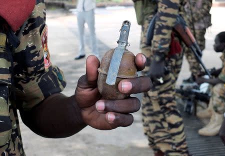 A Sudan People’s Liberation Movement soldier displays an unexploded grenade thrown by attackers during the recent fighting outside the Presidential State House in South Sudan's capital Juba, July 14, 2016. REUTERS/Stringer