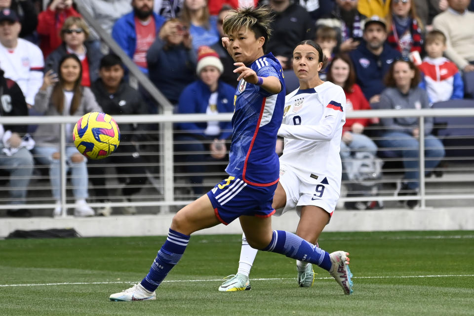 U.S. forward Mallory Swanson, right, kicks the ball past Japan defender Moeka Minami during the first half of a SheBelieves Cup soccer match Sunday, Feb. 19, 2023, in Nashville, Tenn. (AP Photo/Mark Zaleski)