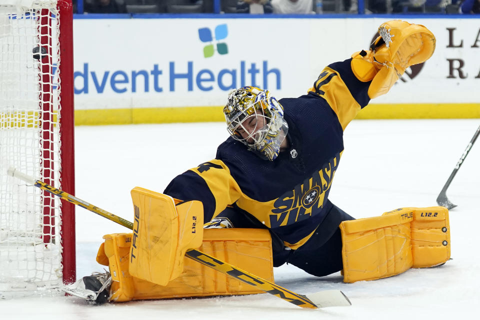 Nashville Predators goaltender Juuse Saros (74) can't make the save on a goal by Tampa Bay Lightning center Steven Stamkos during the second period of an NHL hockey game Saturday, April 23, 2022, in Tampa, Fla. (AP Photo/Chris O'Meara)